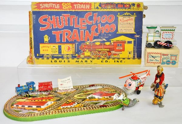 6Pc Tin Toys Lot: Includes a Marx Shuttlin' Choo-Choo, 20X9 1/2" platform, mechanism functional with rough box; 2 Chein clowns, functional; Japan, Santa copter, functioning; TPS Clown Cyclist, functioning, some stainin