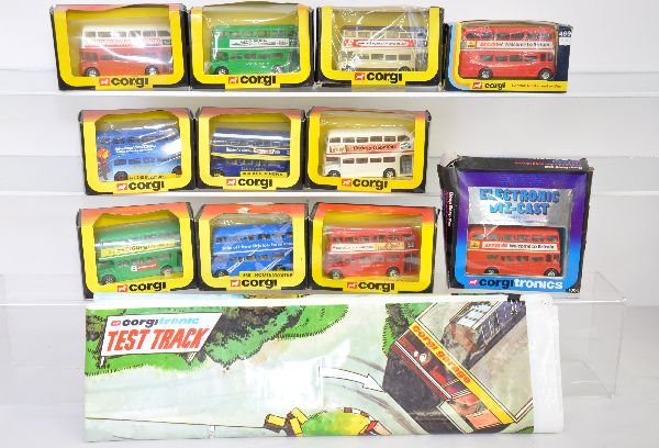 11Pc Corgi Vehicle Lot, Plus: Includes 9 different 469 London busses; 477 Buzbys bus; 1104 Corgitronic bus, in worn box; Plus a Corgitronic plastic "Test Track" play mat. Vehicles appear new in shop worn boxes, C9