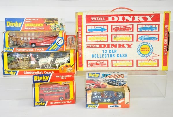 5Pc Boxed Dinky Lot: Includes a 111 Disney Cinderella's coach; 201 Plymouth Stock Car; 267 Paramedic truck set; 289 London bus & an empty Mini Dinky cardboard carrying case; 278 Plymouth Taxi, dirty in dirty box. Otherwis