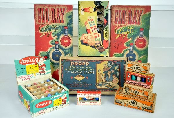 Assorted Boxed Vintage Christmas Lights: Includes 2 Noma 3017 Glow-Ray light sets; Santa Lites clip-on set, nice box; Factory store display case of Amico outdoor 120vt lights(25ct); Propp #72 Mazda light set; 5 smaller boxed bulb sets. Large