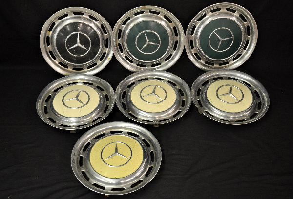7 Vintage Mercedes Hub Caps: Includes a set of 4 in cream; 2 in green & one black version. One green piece has some rust under paint, otherwise all show moderate wear and should clean-up a bit. Examine photos or call for more inf