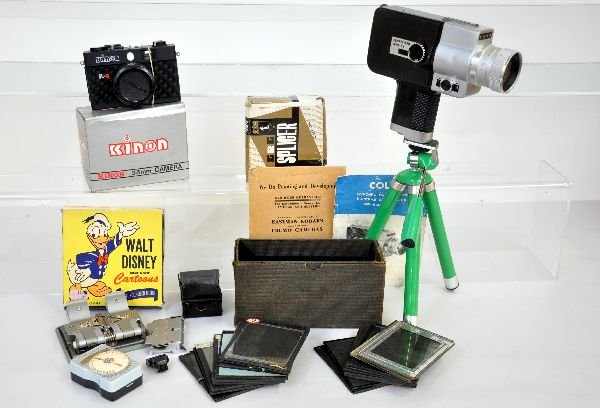 Photographic Related Lot: Includes a Colt Super-8 Zoom movie camera with booklet; table top deco tripod; Disney cartoon movie in box; Splicer & light meter in cases; Kinon 35mm camera new in box with leather case; group of ear