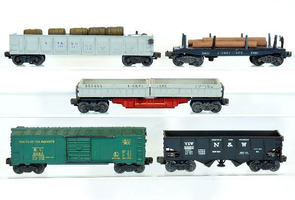 5 Lionel Freight Cars: Includes 3461 operating lumber dump; 3359-55 double dump car; 3456 N&W operating hopper; 6464-75 RI boxcar, type I; 3562-25 barrel car with load, missing figure. All show light playwear and should cle