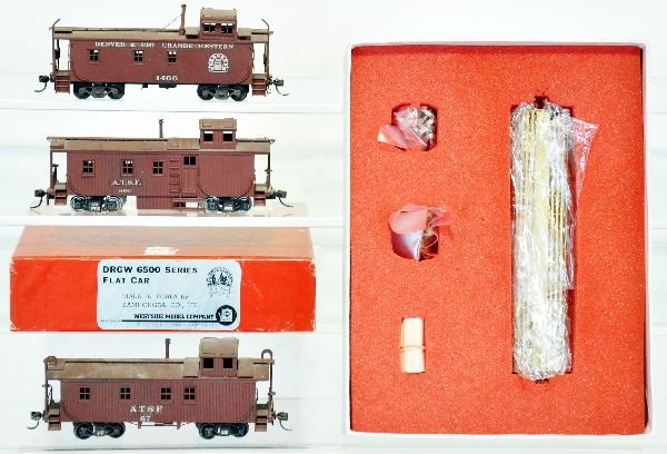 4 HO Brass Freight Cars: Includes a boxed Westside DRGW 6500 series flat car, unpainted brass new in box; Plus 3 wood side cabooses, marked AT&SF #860; Denver & Rio Grande Western #1466; ATSF 67. They have been professionally