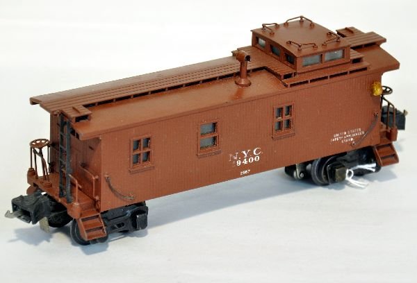 Clean Lionel 2957 NYC Semi-Scale Caboose: Clean with fairly straight castings. From underneath, maybe a credit card width warp, very minor with straight floor. It has high box couplers and shows light playwear, otherwise C7