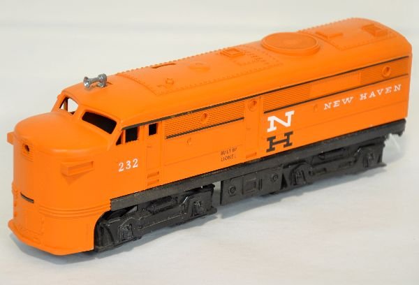 Lionel 232 NH Alco Diesel: Very clean body with nice matte patina and strong bright lettering. There is a 1/4" paint chip on back edge of cab, otherwise C8. Chassis has surface oxidation throughout & on chrome part of trucks
