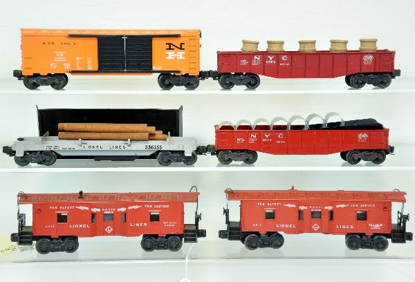 6 Lionel Freight Cars: Includes 6342 culvert gondola; 3361 lumber dump, complete; 2 #6517 bay window cabooses, 1 has broken stack; 6462 painted gondola with drums; 6468 NH boxcar, 1/2 serif lettering. A bit dusty, but all s