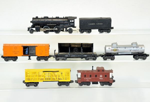 7Pc Lionel 1655 Steam Freight Set: Includes 1655 steam loco; 1654W tender; 3464 SF operating boxcar; 6465 Sunoco tank car; 6656 stock car; 3461 lumber car, some oxidation on platform; 6357 caboose. All show moderate playwear, C6-6+