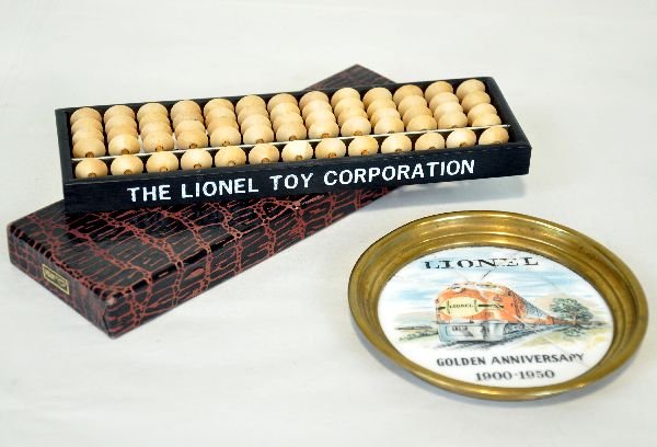 2 Early Lionel Promotional Items: Includes the 1966 abacus, 2 letters flaking one side, but clean with original sleeve; 1950 anniversary porcelain coaster, bottom cracked & repaired