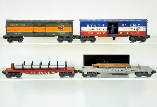 4 Lionel Freight Cars: Includes a 3361-55 log dump with bin, new logs; 6511 flat with 2 pipes, 1 cracked; 6464-450 GN Boxcar, type IIB, I decal is 90%; 3494-275 SOM operating boxcar, unusual with no number on car version. A