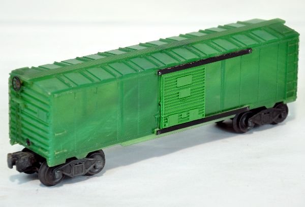 Lionel Pre Production Boxcar Sample: Unusual translucent green plastic with light green doors. Frame is metal stamped 00-6464-009 LIONEL. It has staple end trucks with magnetic couplers. It does show some runtime with a C8 body. Unusual