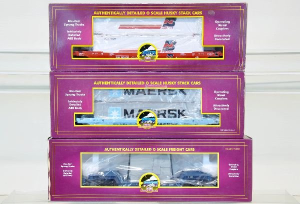 3 MTH Freight Cars: Includes a 20-98109 depressed flat with transformer; 20-95006 & 20-9502L Husky stack flat cars. They show light runtime with c9 bodies & boxes, one box shows shop wear