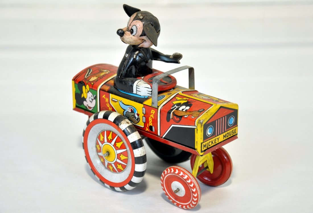 Scarce Early Marx Mickey Mouse Dipsy Car: Litho tin, 6" long, mechanism is functional. It has Mickey's original ears, but shows some oxidation spots on arm. Could use a cleaning. Overall shows moderate playwear, C6