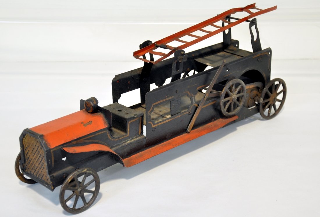 Early Dayton Friction Aerial Ladder Truck: Painted pressed steel, 20" long with friction drive & iron wheels, missing side ladders, repainted