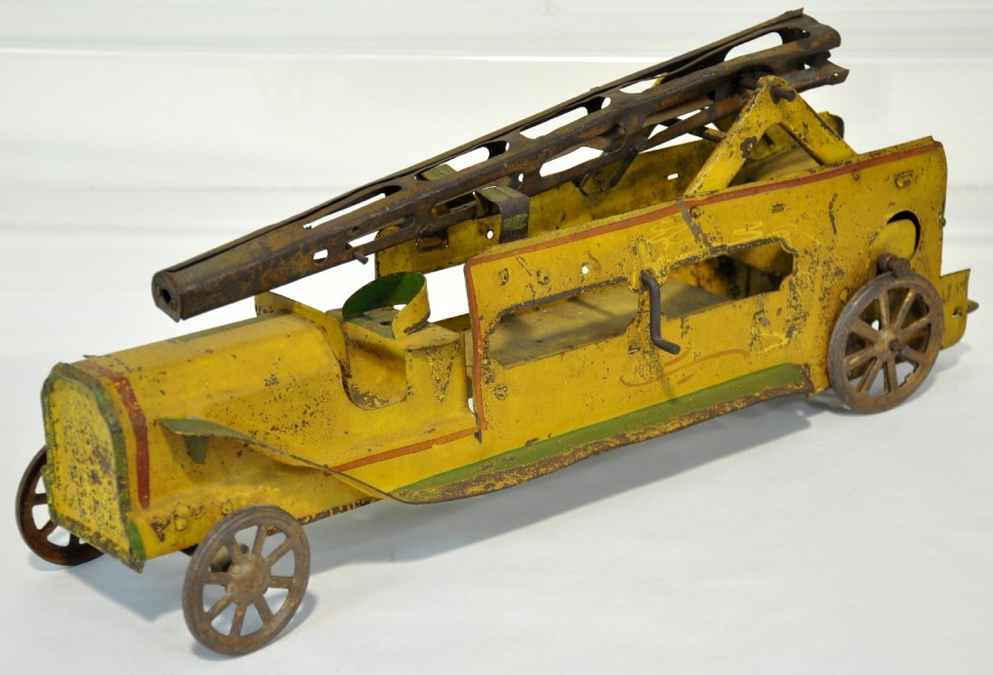 Early Dayton Friction Fire Water Tower: 20" long, hand painted pressed steel with friction motor. Nice original paint, just missing ladder elevator string. It shows moderate to heavy playwear, C4-5
