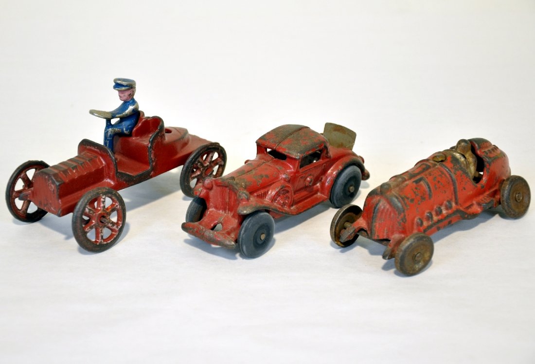 3 Cast Iron Vehicles: Includes a 5" Hubley racer; Champion coupe with rumble seat & rubber tires; possibly Kenton early open roadster with driver. All show moderate to heavy playwear, C3-4