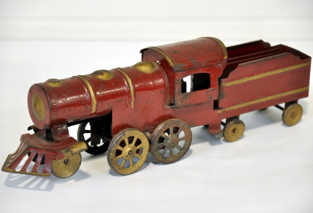 Dayton Friction Locomotive: Painted pressed steel, 12" long with friction motor. It is clean & shiny, showing moderate playwear, C5-6