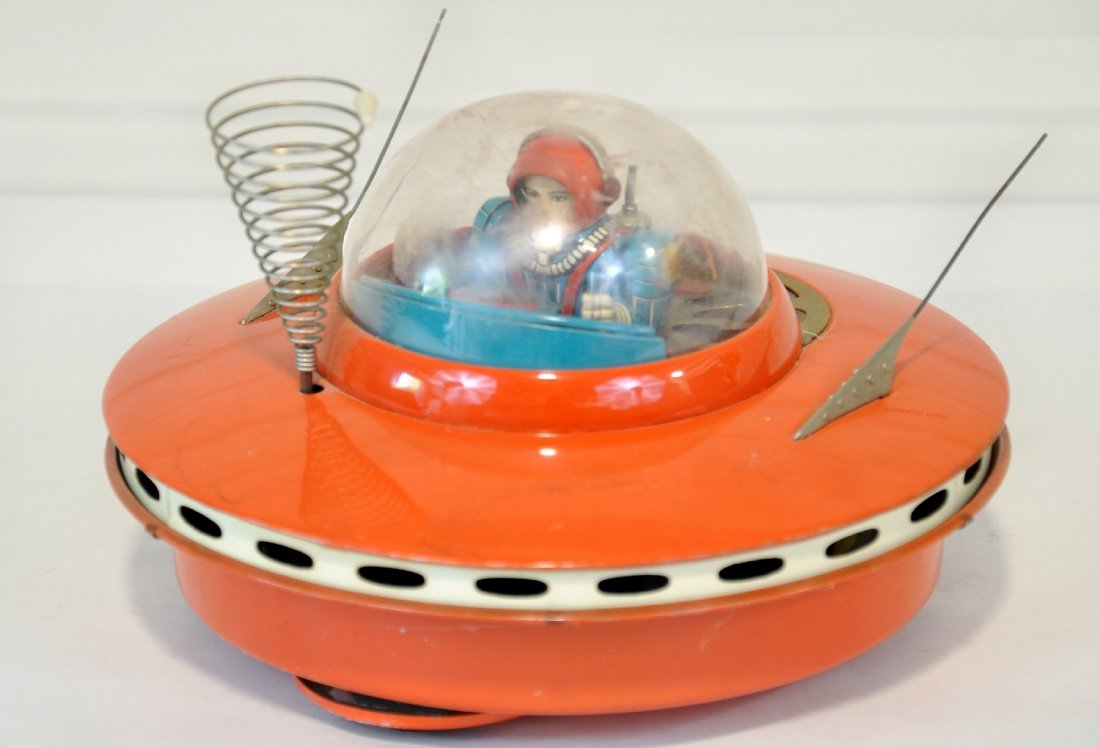 Japanese Flying Saucer with Space Pilot: KO Japan, Litho tin, battery toy, untested, with some battery damage as shown in photo. Body is very clean & shiny with scarce antenae intact. Otherwise appears C8