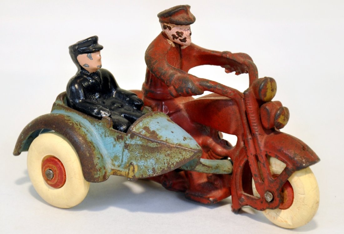 Hubley Harley Davidson Motorcycle & Sidecar: 5" painted cast iron with original passenger. It has hard white rubber tires over wood hubs. It shows moderate playwear, C5+-6