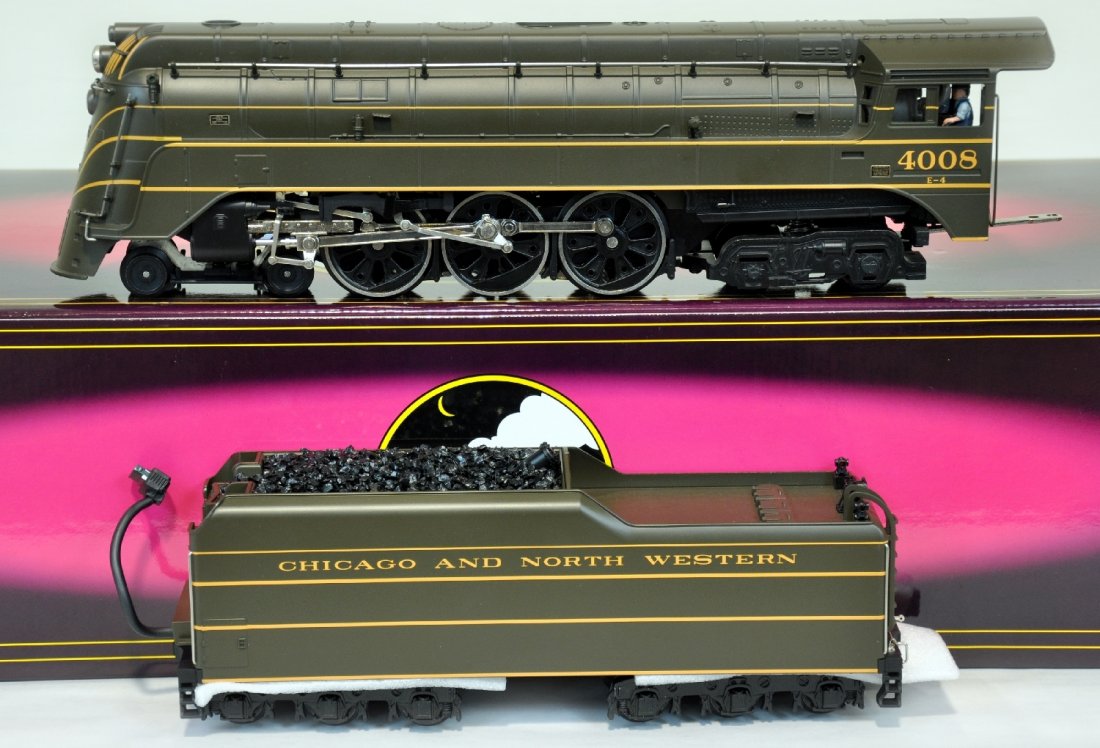 Mint MTH 20-3034-1 C&NW E-4 Steam Locomotive: 054. Nice streamline 4-6-4 steam engine equipped ProtoSounds with squeaking brakes passenger station effects. It has been test run with box, C10