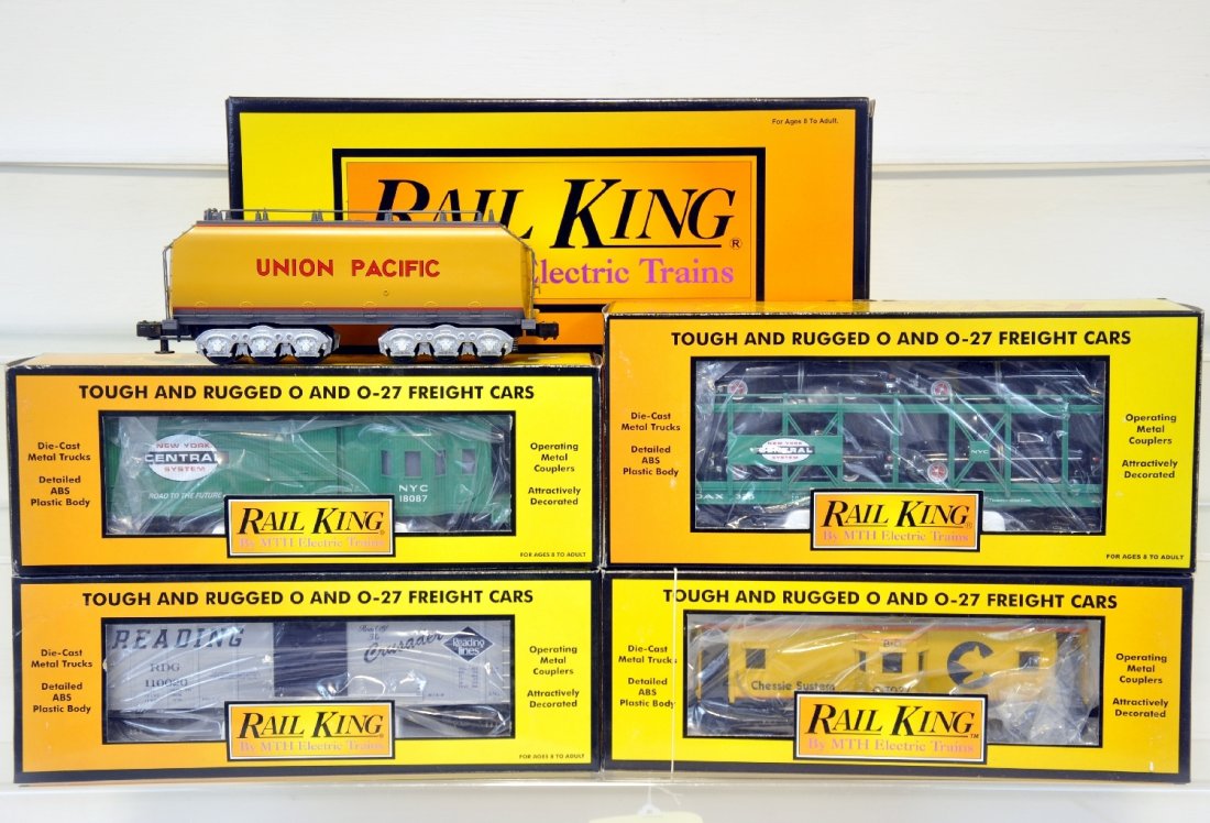 MTH RailKing Aux Tender and Freight Car Lot: Includes Union Pacific Auxiliary Tender 30-1130, Chessie Caboose 30-7713, Reading Boxcar 30-7438, New York Central Work Caboose 30-7726, New York Central Auto Carrier Flat Car 30-7662. Pieces are unru