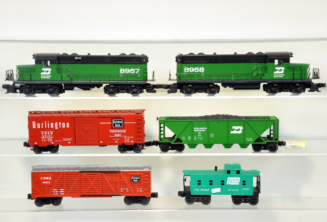 Burlington Northern 6 Pc Freight Train: Includes Lionel Burlington Northern SD40 powered/dummy set powered unit is missing body screw. Operating Stock Car, 4 Bay Gondola, Box Car, and Caboose. Cars are unboxed and show moderate run time. C9