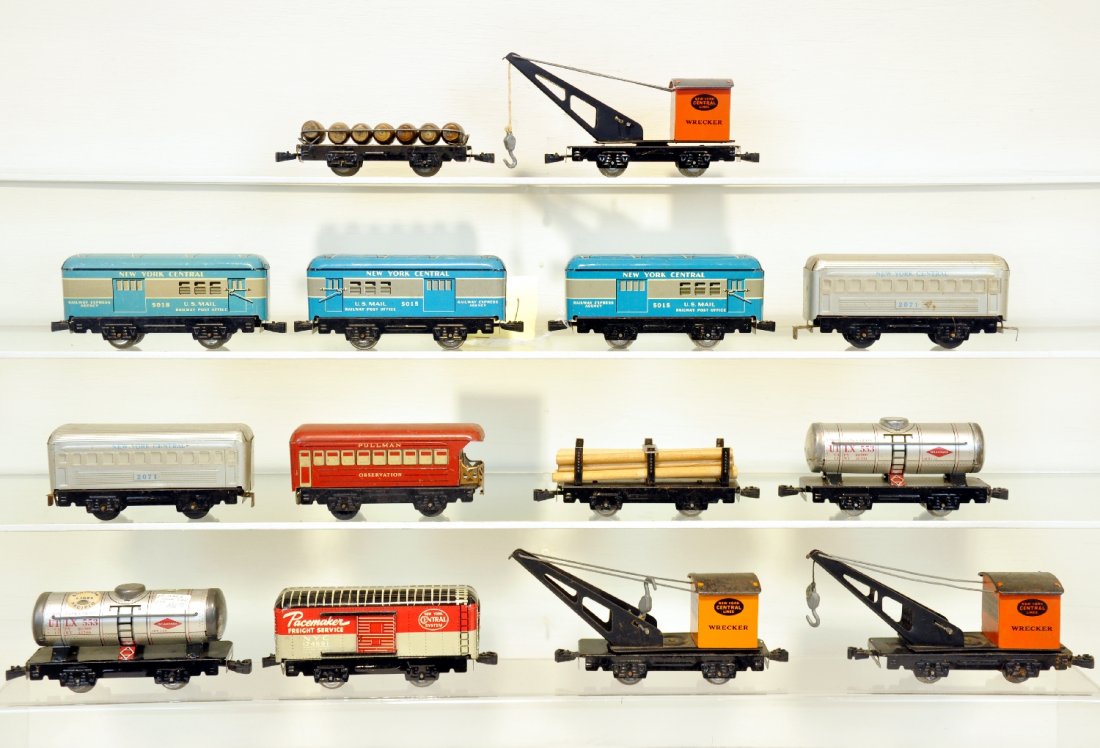 14 Clean Late Marx Tin Freight Cars: Includes 3 baggage cars (2 #5015, 5018); 2 #2071 NYC coaches; Scarce 174591 NYC boxcar, sticker added to one end; 2 tank cars; 3 cranes; log flat, missing springs; barrel flat. Otherwise all show ligh