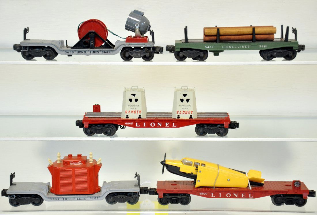 5 Lionel Freight Cars: Includes 6800 flat with airplane, tougher yellow over black version; 2461 flat with red transformer; 3461-25 log dump car; 6805 Flat with NEW canisters, handles intact but glued to flat car; 3650 sear