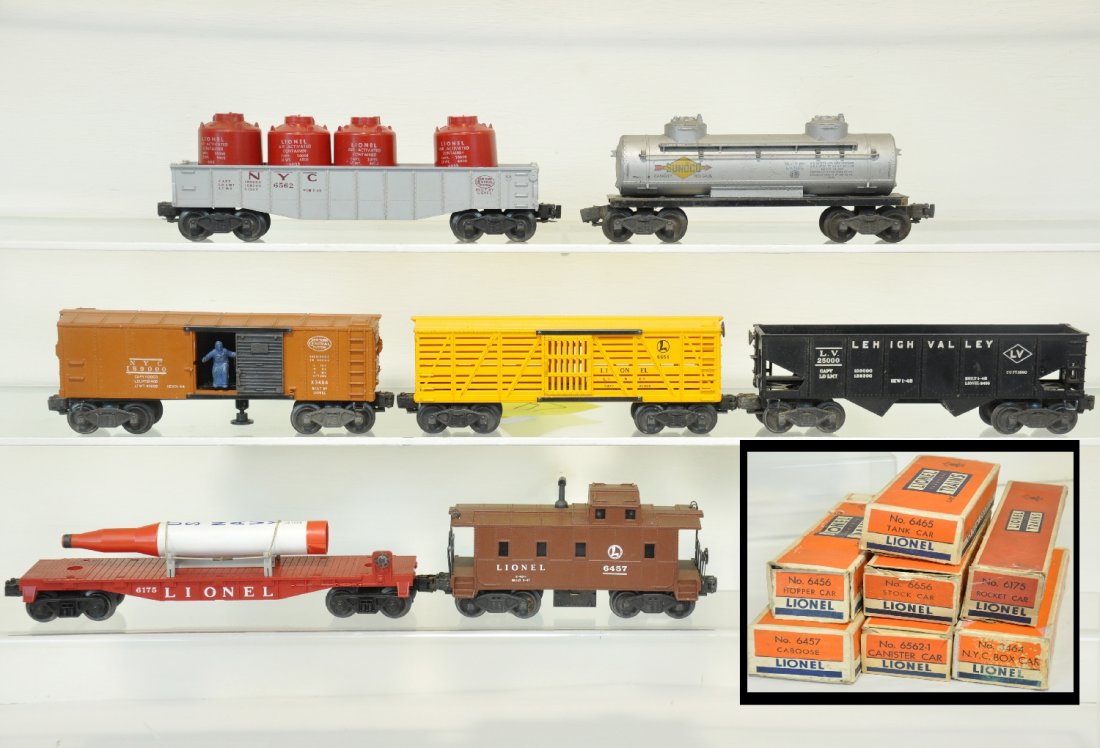 7 Boxed Lionel Freight Cars: Includes a 6465 tank car; 3464 NYC operating boxcar; 6175 rocket flat (foam tip is loose); 6562 gondola with canisters; 6656 stock car; 6457 caboose; 6456 LV hopper; All show light playwear with boxes
