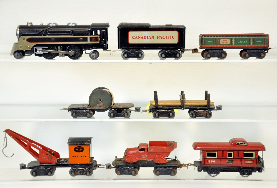 9Pc Marx CP Freight Set: Circa 1938; Including a 391 steam loco; CP tender; 552 gondola; NYC crane; Reel flat; log flat with 4 logs & hold-down; empty barrel flat; dump truck; 556 4-wheel caboose. Grades range from C5 to C7 s
