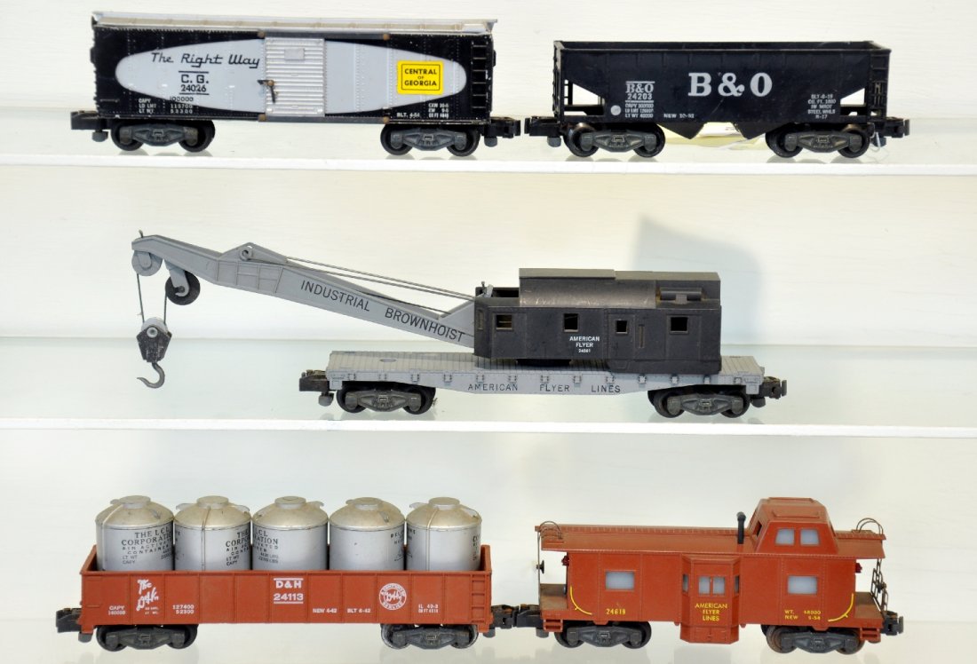5 American Flyer Freight 5-Digit Cars: S Gauge. Includes a 24619 bay window caboose; 24113 D&H gondola with containers; 24203 B&O hopper, 1 cracked step; 24026 C of G boxcar; 24561 crane. All have iron trucks and could use a cleaning, C6-7