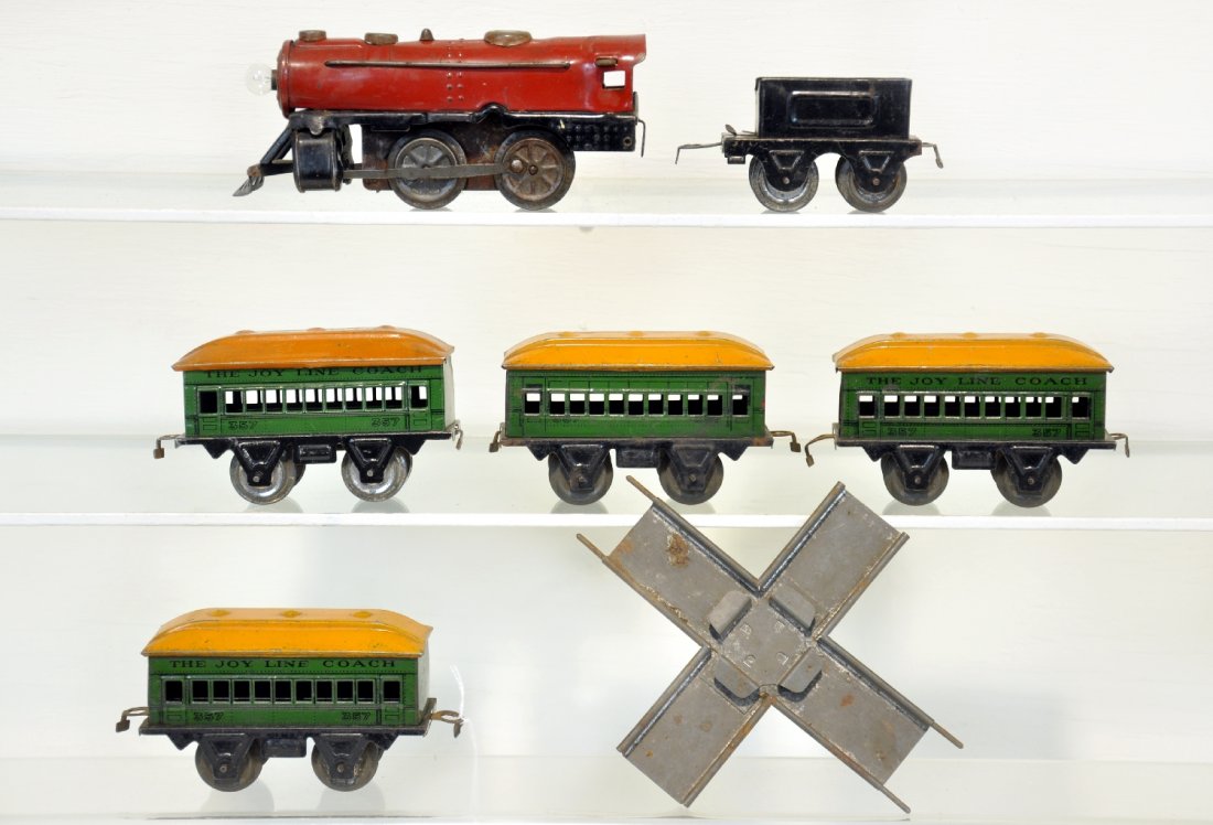 Marx Joy Line Train Set: Includes a red steam loco with battery op headlight, untested, mechanism is functional, no key; tender with coal pile; 4 #357 coaches & cross track. All show moderate playwear, C5-6