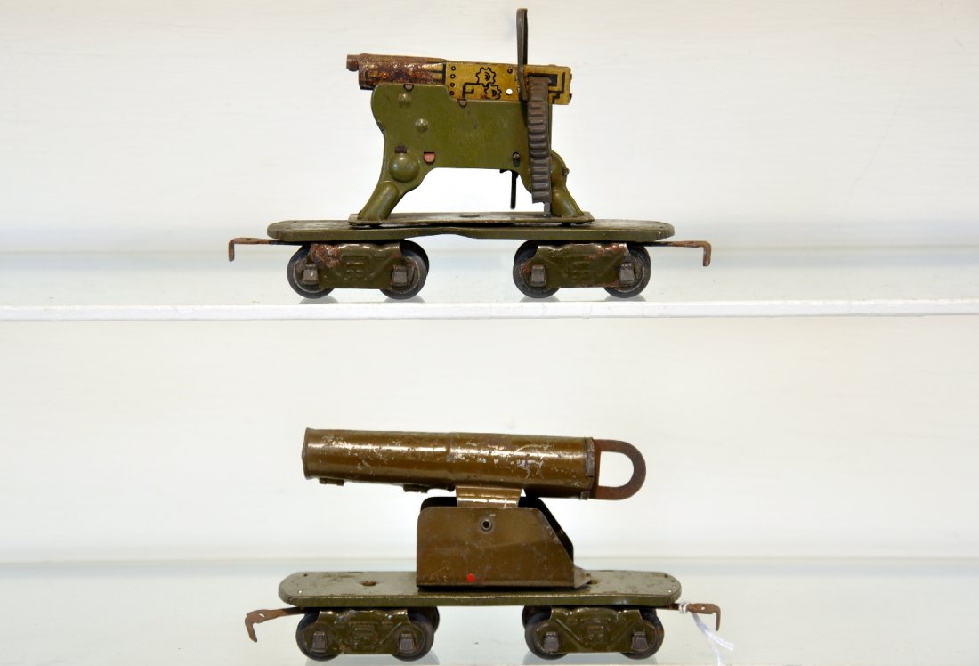 2 Marx Pre War 8-Wheel Military Cars: Includes a clicking matching gun, some rust on barrel; flat with field gun, mechanism intact. Otherwise both show moderate playwear, C5-6