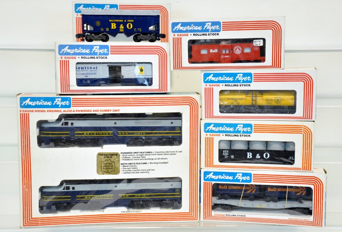 Lionel American Flyer B&O Freight Set: S Gauge. Includes Baltimore & Ohio Historic American Railroad 8153, boxcar 9702, tank car 9102, gondola 9301, hopper 9201, flatcar with Vans 9000, illuminated caboose 9401. These cars are unrun in Obs