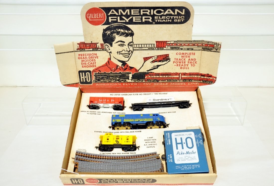Unusual American Flyer HO Set 30705: HO Gauge. Includes a C&O F7 A diesel; 33214 SF Cement car; 33545 Borden's flat with container; 33621 C&O bay window caboose. All are intact with track & transformer. Crisp insert with set box, like ne