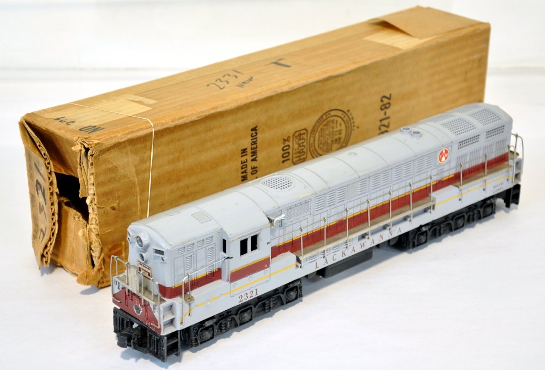 Boxed Lionel 2321 Lackawanna FM: Nice pulling dual motor diesel. It has hairline screw cracks both sides with a small corrosion spot on battery box, more on bracket. It has been cleaned and fully functional with box. It shows moderat