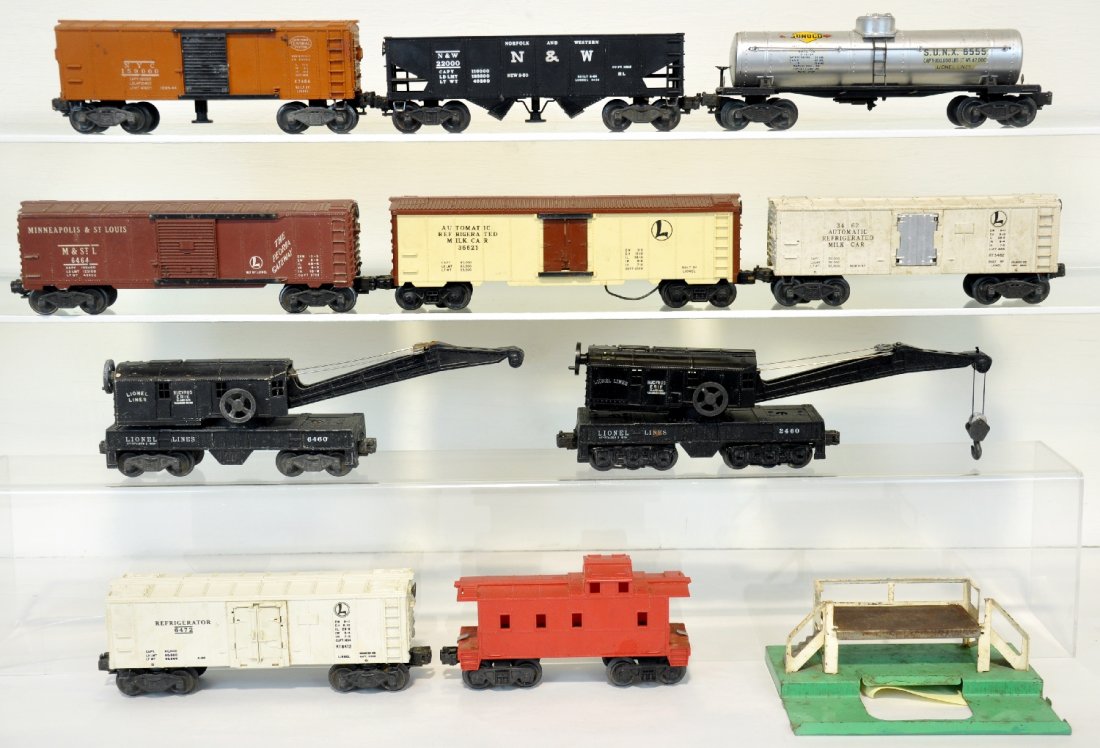 10 Lionel Freight Cars: Includes 2460 crane; 6460 crane; 2555 tank car; 3484 PRR operating boxcar; 3464 operating boxcar; 3462 milk car with platform; 6472 reefer; 3661 milk car; (6167) caboose; 3456 N&W oper hopper All show