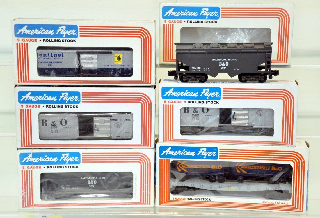 6Pc Lionel American Flyer B&O Freight Car Lot: S Gauge. Includes 2 covered hoppers 9207; 2 boxcars 9709; boxcar 9702; flatcar with vans 9000. Some cars show light run time. Obs included. C10 bodies