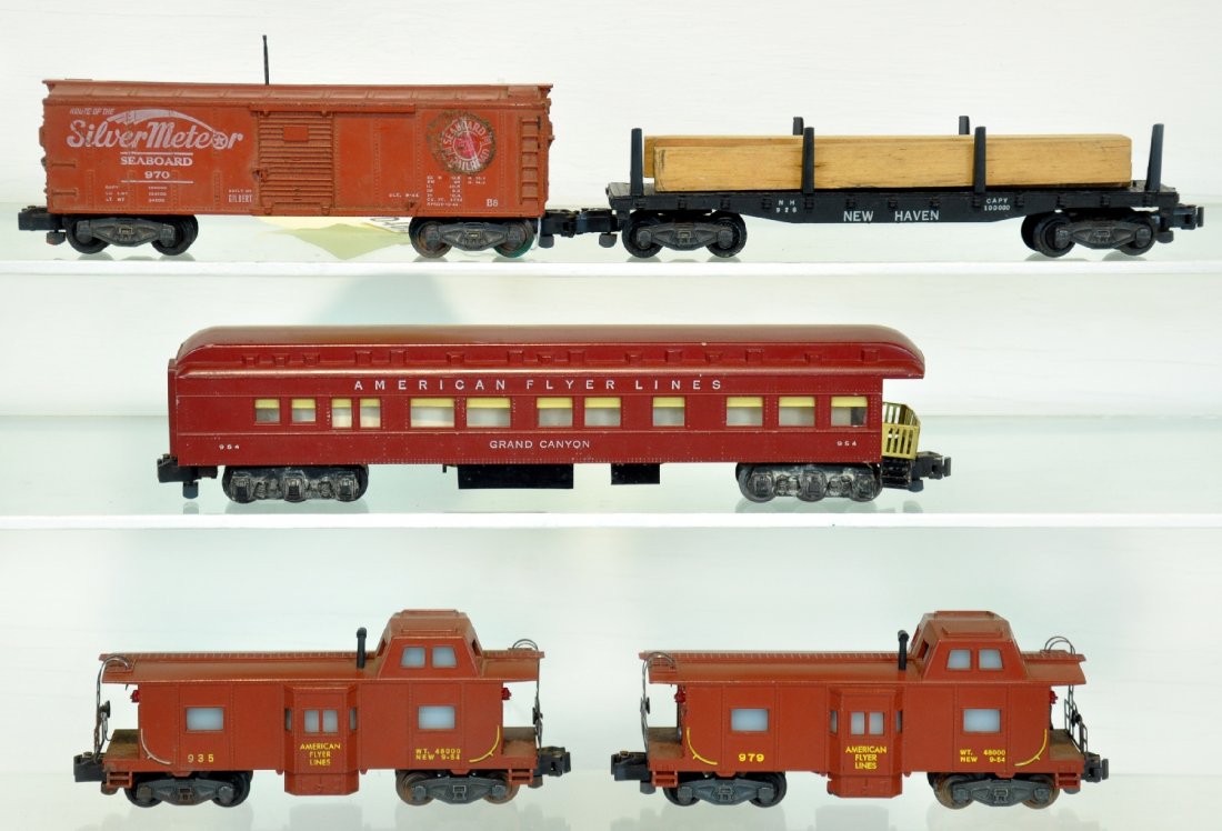 5 American Flyer Cars: S Gauge. Includes a 979 action caboose; 928 lumber car, missing 2 stakes; 935 bay window caboose; 954 Grand Canyon observation; 970 Silvermeteor operating boxcar, missing figure, C6. Otherwise all sho