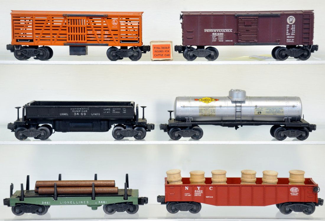 6 Clean Lionel Freight Cars: Includes 3461-25 lumber dump, replaced logs; 6555 Sunoco tank car, nice decals; 3469 coal dump car; 6454 PRR boxcar; 6462 gondola with drums; 3456 operating cattle car only with -9 cows box. They show