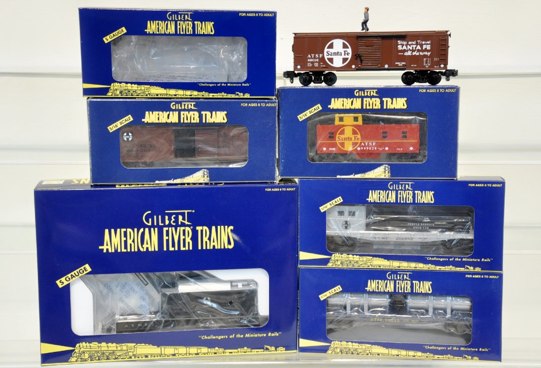 Lionel American Flyer 6 Santa Fe Freight Cars: S Gauge. Includes walking brakeman car 49016, AT & SF boxcar 48329, CBS square window caboose 48721, boom car 48723, flatcar 48527, crane car 49012. These cars are unrun. C10