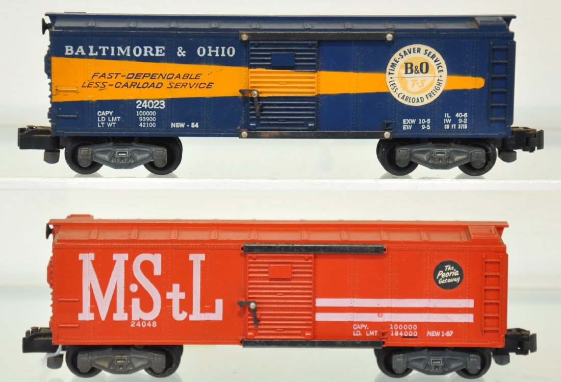 American Flyer 24048 & 24023 Boxcars: S Gauge. Includes a 24048 M&StL; 24023 B&O with intact stickers. They have light oxidation spots on frames and show light to moderate playwear, C6+