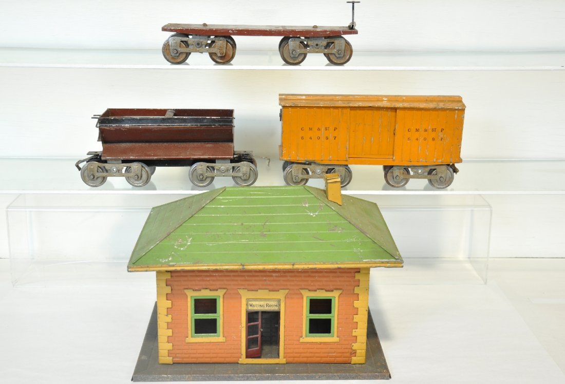 4Pc Early Lionel Lot: Includes a 121 Station, missing 1 chimney; standard gauge 11 flatcar, 16 PRR side dump car; 14 boxcar, all show moderate playwear and need a cleaning, otherwise C5-6