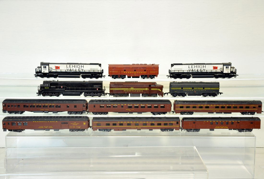 12Pc PRR & LV HO Trains Lot: Includes AHM LV AA Diesels, cabs 633 & 638; AHM Dummy diesel cab 6539; ROCO PRR Sharknose; 2 F series b-units; 6 RivaRossi streamline passenger cars. All show light to moderate playwear, C7-8