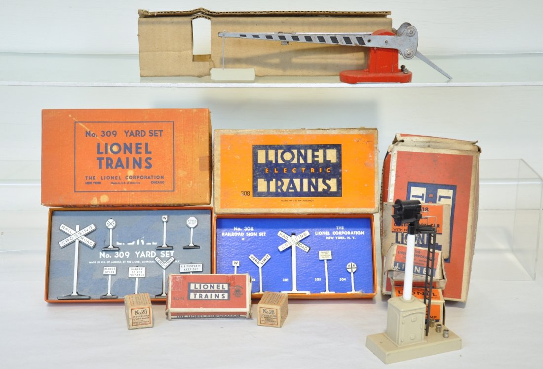 Lionel Accessory Lot: Includes a 308 sign set; 308 sign set; 152 crossing gate with insert only; 263 block signal, ob; 2 #28 bubs, obs; 39-3 bulb, ob; 012 bulb & cap; 362-78 barrels, ob, C6-8