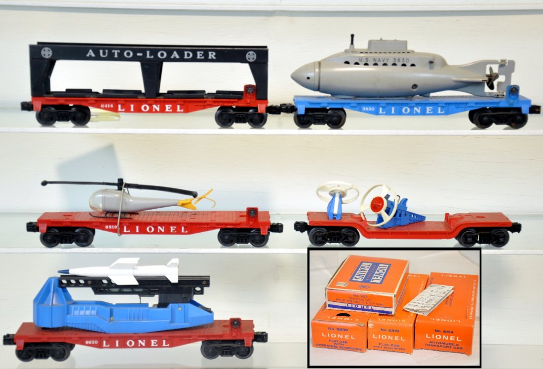 6Pc Lionel Group, Some Boxed: Includes a 3830 flat with sub, tail broken with instructions, ob; late 6414 EMPTY auto-loader with box; 6819 flat with helicopter, tail loop broken, ob; 3349 turbo missile car; 6650 ICBM launcher. All