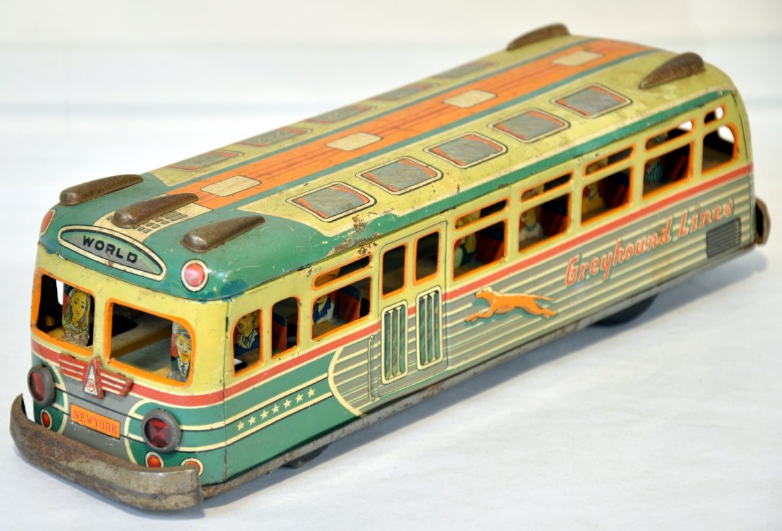 Unusual Japanese Greyhound Bus: By San, 11 1/2" litho tin friction bus. Mechanism is functional. Has wonderful tin riders inside and has a great look. The chrome has some rust and it shows moderate playwear, C5