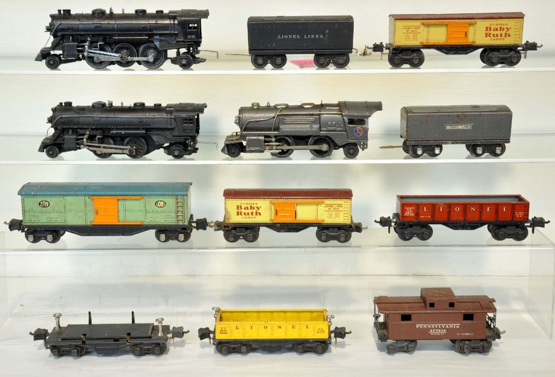 12Pc Pre War Lionel Trains Lot: Includes a 259E loco with 1689T tender, gunmetal; 1664 loco with 1689T tender; 224E loco only; 3652 gondola; 3651 lumber dump; 2689 boxcar; 2677 gondola; 1689 boxcar; 2672 caboose, missing 2 wheels; 2