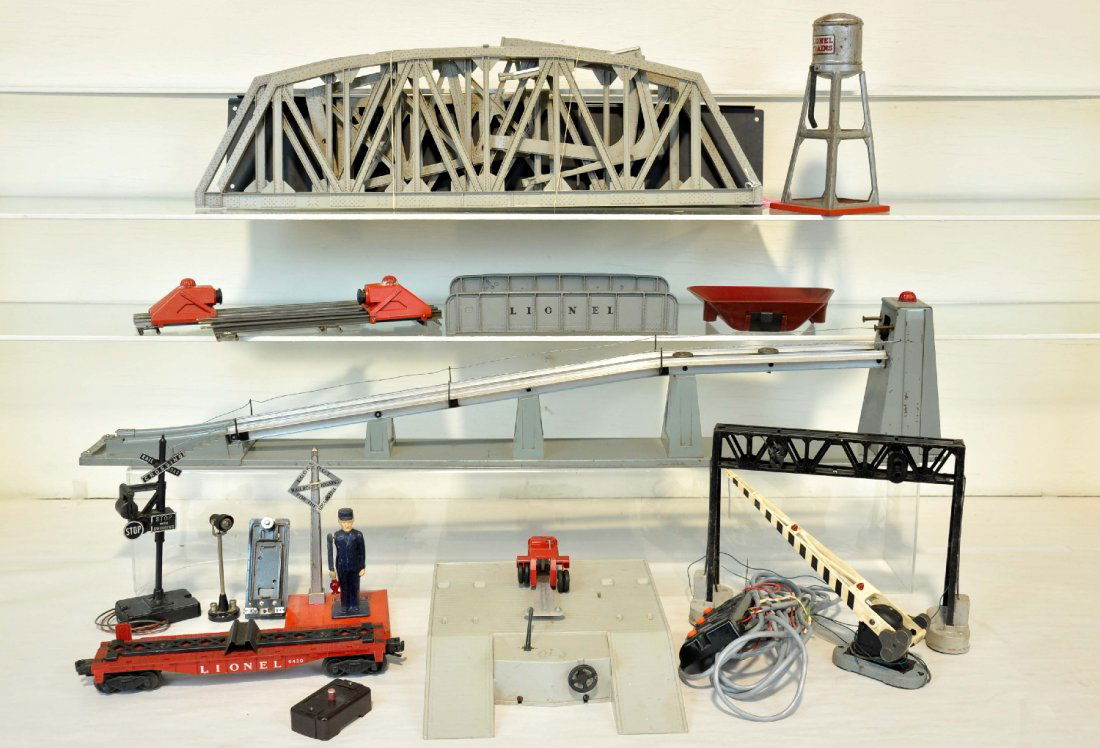 11Pc Lionel Accessory Lot: Includes a 456 coal ramp, no car, rewired; 450 signal bridge; 252 crossing gate; 1045 flagman, no flag; 2 #260 bumpers; 314 girder bridge; partial 450 piggy-back unloading set; 93 water tank; 140 banj