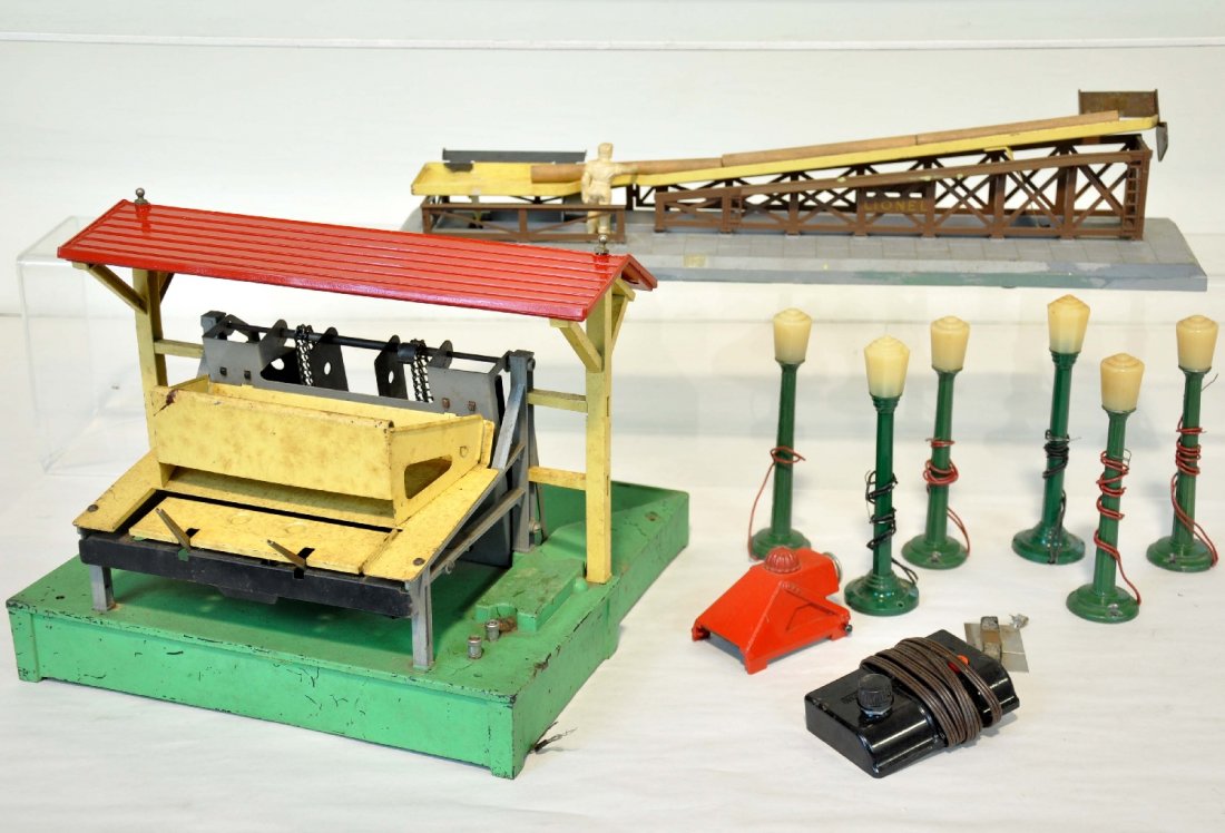 Lionel Accessory Lot, Plus: Includes a Lionel 164 lumber loader with 3 logs & rewired controller; 362 barrel ramp, some layout paint on base; 260 bumper; 6 cast Colber lampposts. All show moderate playwear, C5-6